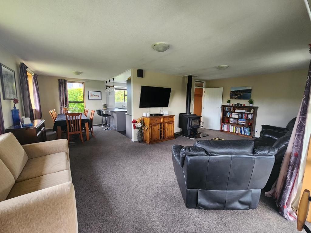 a living room with a couch and a television at Rockhampton in Kurow