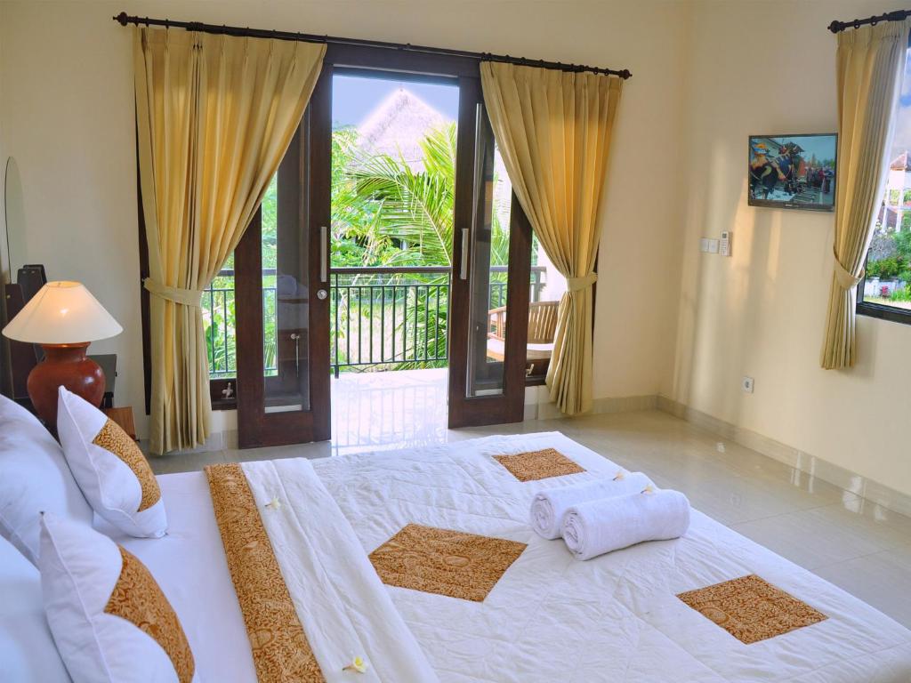 Postel nebo postele na pokoji v ubytování Eka Bali Guest House