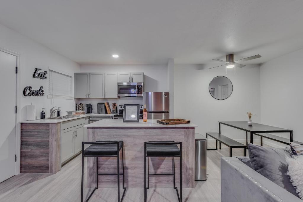 a kitchen with a counter and stools in a room at Brand New Luxury Apt! Heart of Montrose- Downtown HTX in Houston