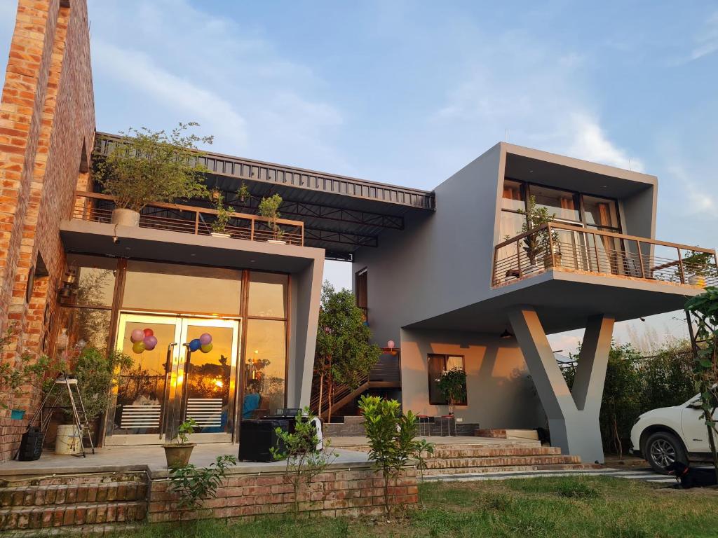 a house with a large window and a balcony at Jolshiri Vacation House in Dhaka