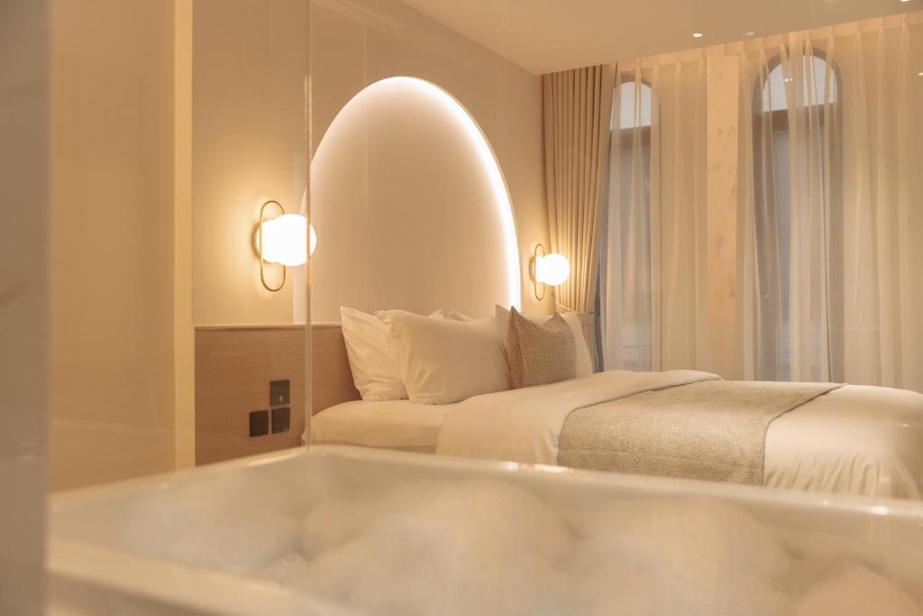 a bedroom with a bed and a bath tub at CORRIDOR 2407 in Bangkok