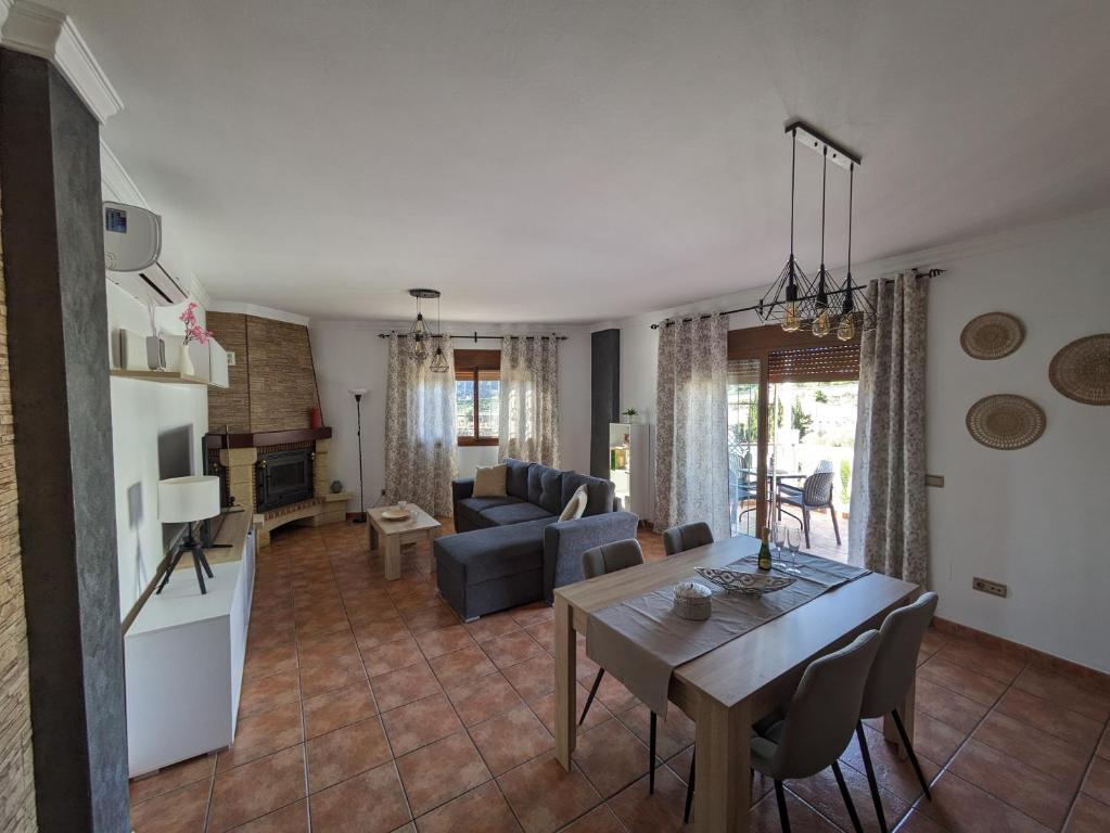 a living room with a table and a couch at Chalet La Noria in Nerja