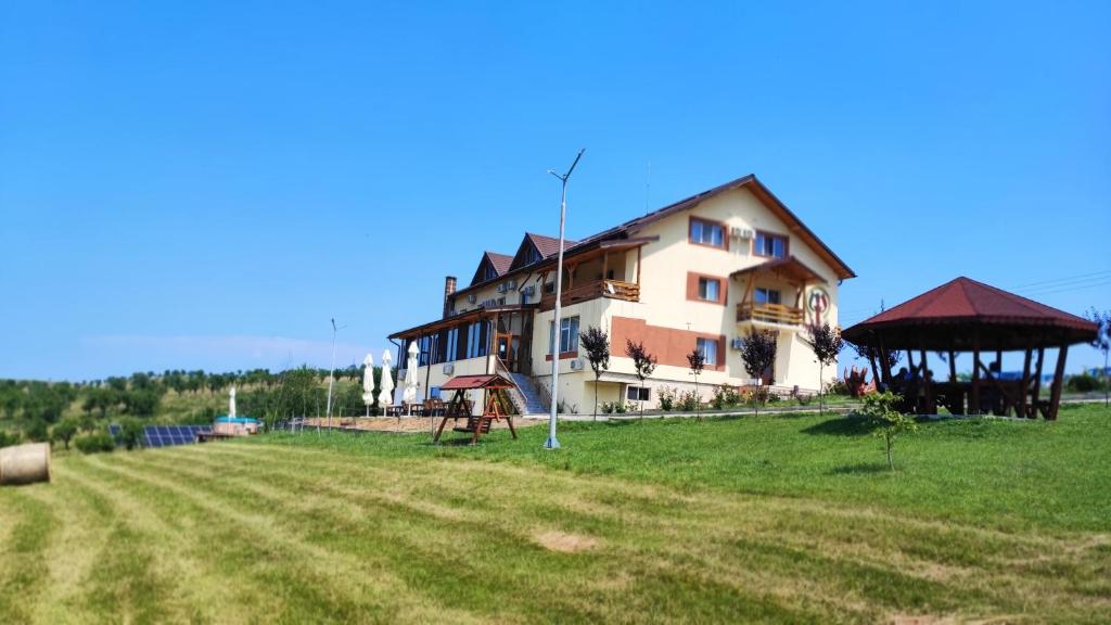 a large building with a playground in a field at MOTEL PRISLOP in Haţeg