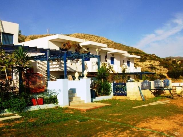 een groot wit huis met een berg op de achtergrond bij Horizon View Studios in Amoopi