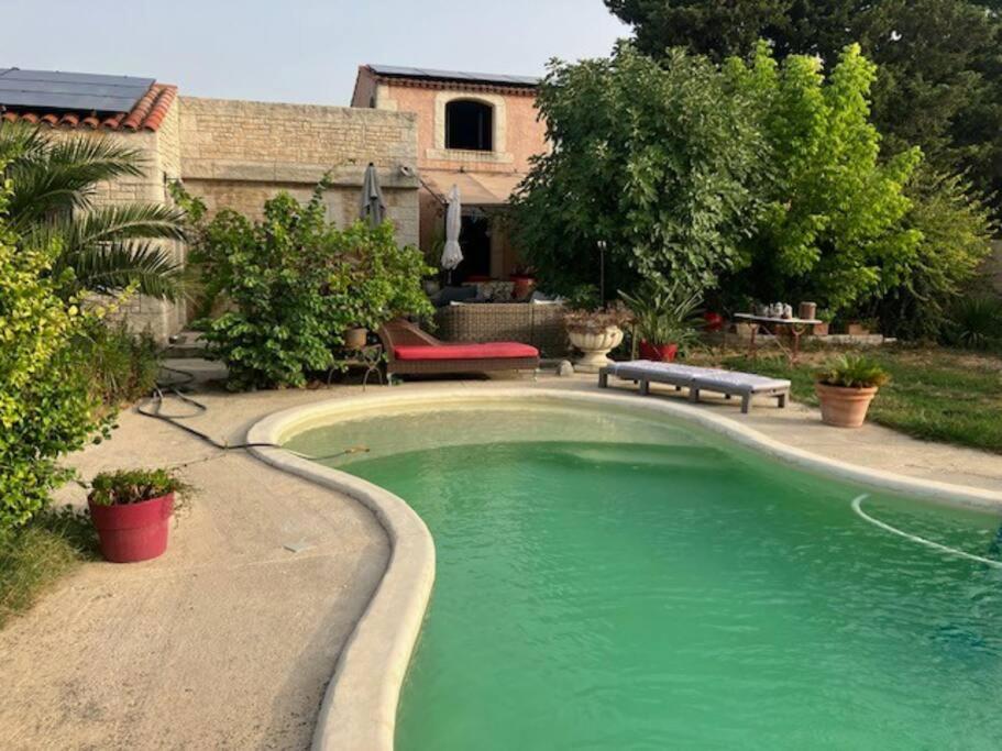 a swimming pool in the yard of a house at Studio Nîmes in Nîmes