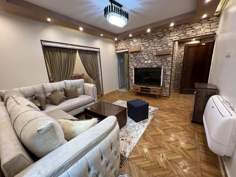 a living room with a couch and a fireplace at Luxurious apartment in the heart of Cairo, Dokki in Cairo