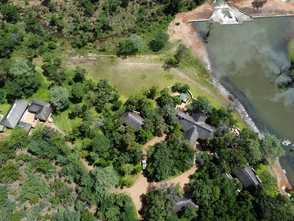 an aerial view of a house with trees and a lake at Ilanga Safari Lodge - Welgevonden Game Reserve in Vaalwater