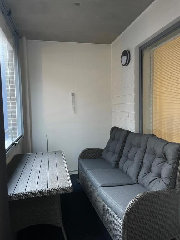 a living room with a couch and a table at Bronx - Apartment in Vantaa