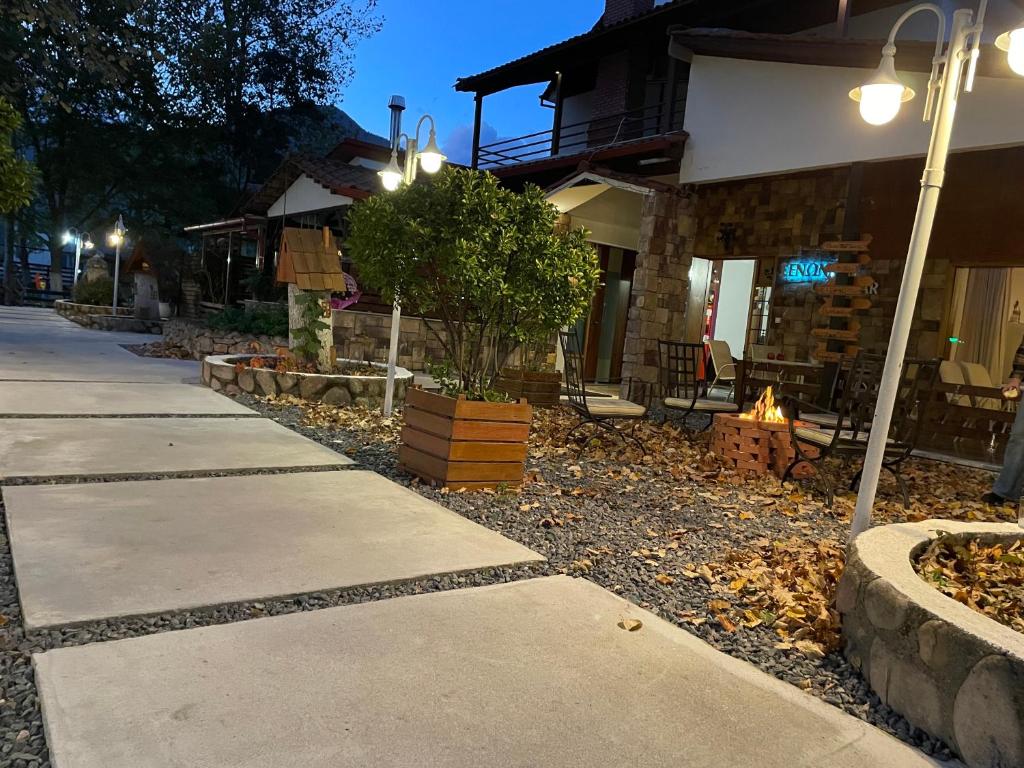 a sidewalk in front of a building at night at Oasi in Kato Loutraki