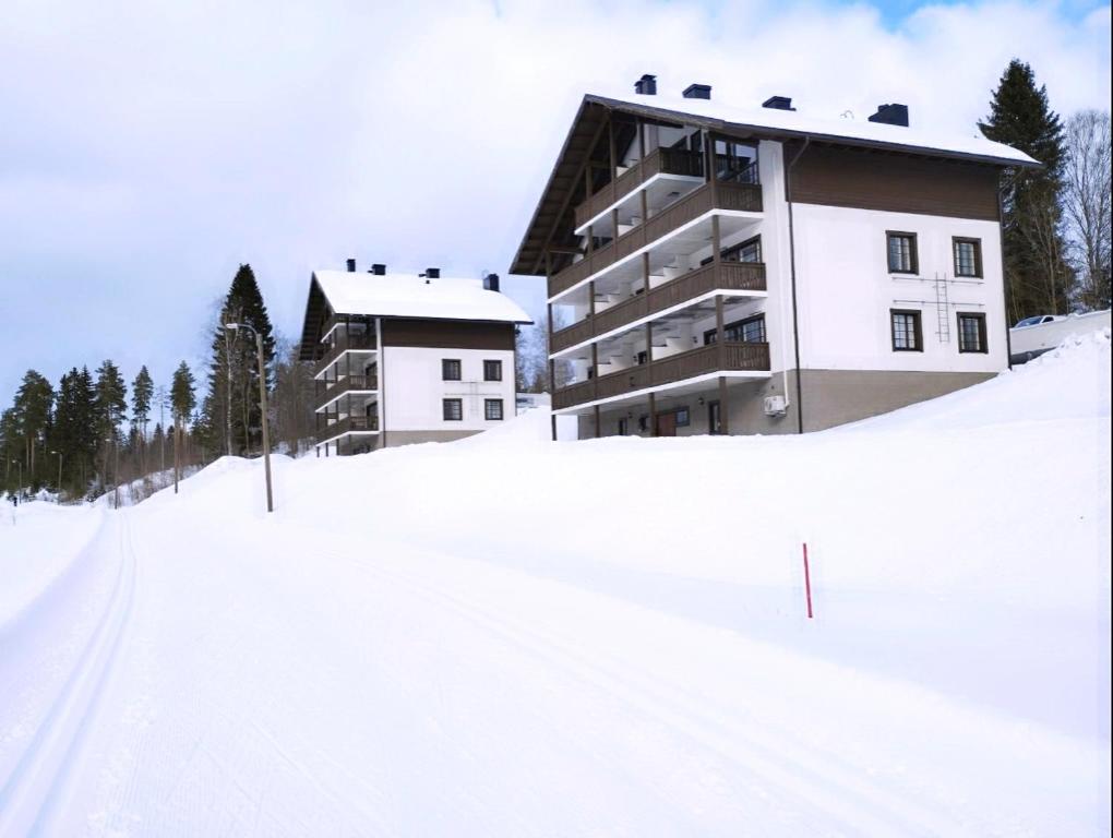 a building on top of a snow covered slope at Apartment Kehtola, Tahkovuori in Kuopio