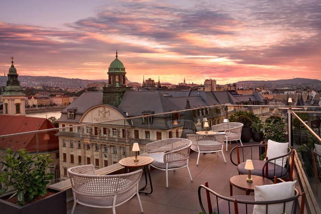 a terrace with tables and chairs and a view of a city at Matild Palace, a Luxury Collection Hotel in Budapest