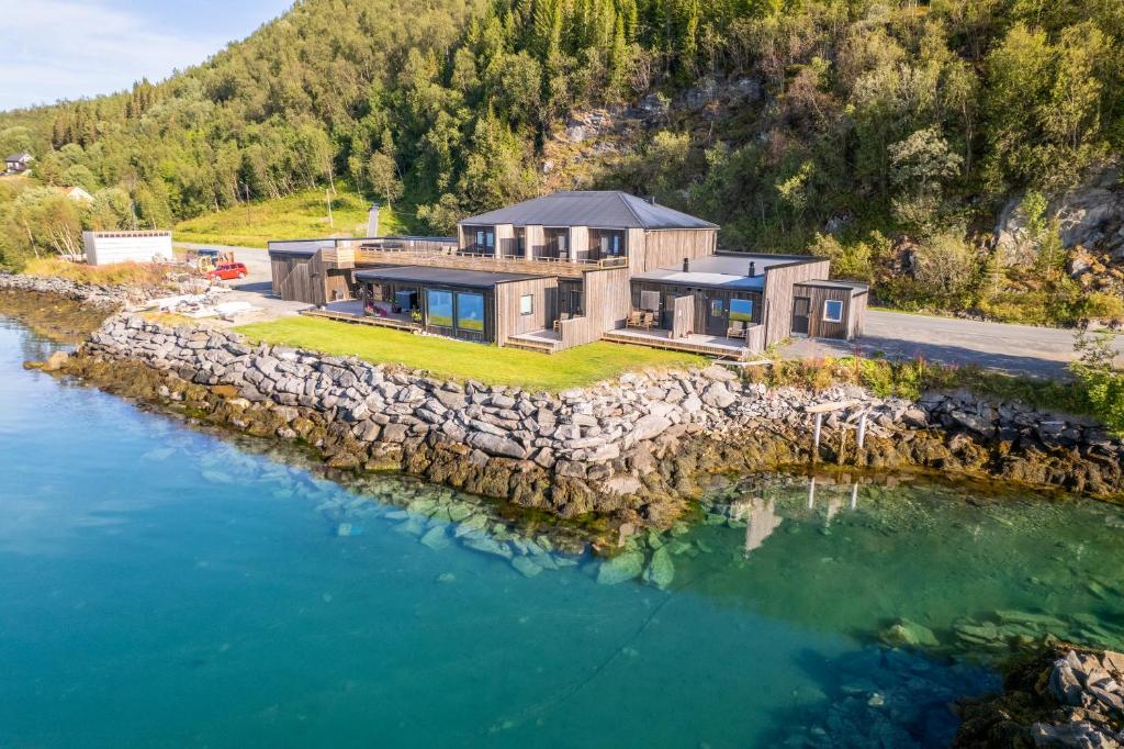 an aerial view of a house on a rocky island in the water at Attme Have 