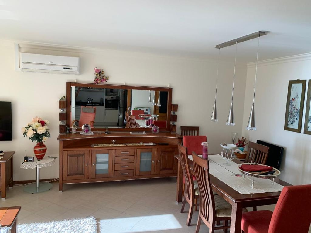 a dining room with a table and a large mirror at Laginha Beachview in Mindelo