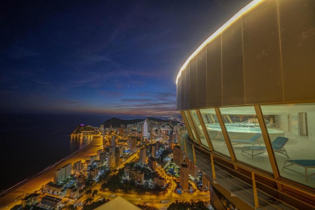 a view of a city at night from a building at Intempo Residential Sky Resort & Spa - Benidorm, España in Benidorm