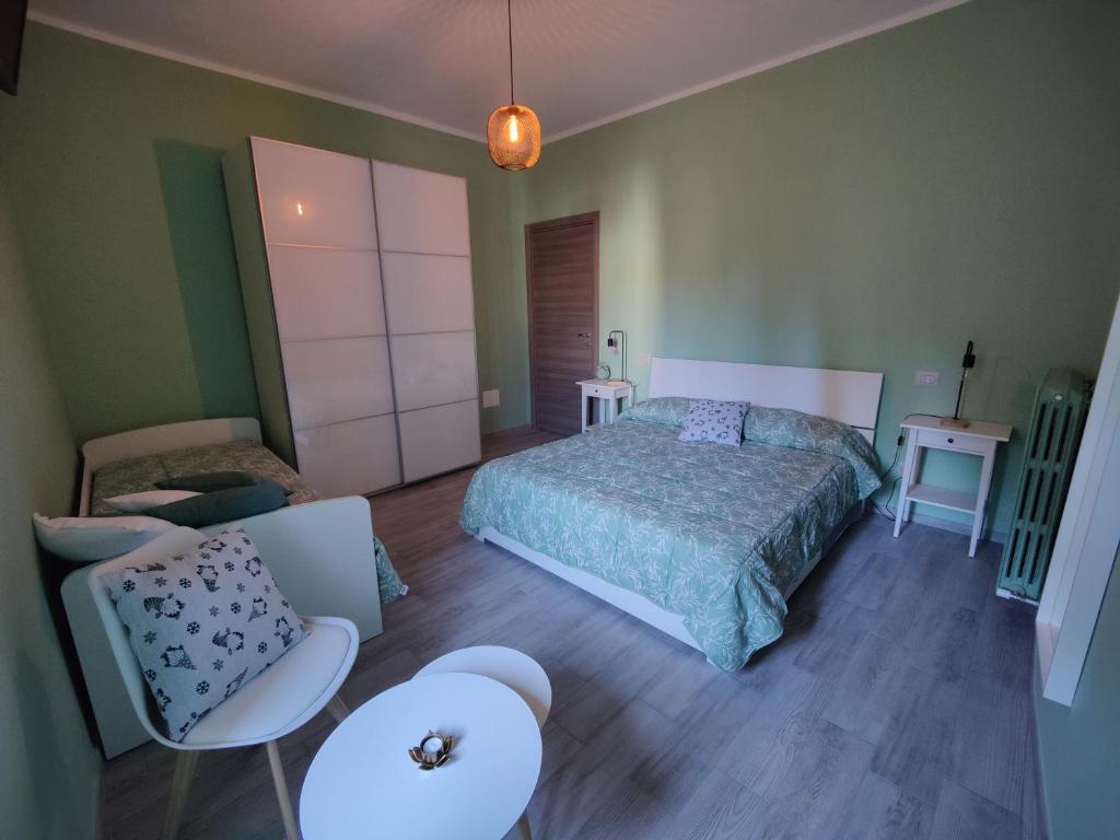 um quarto com uma cama, uma cadeira e uma mesa em Il Vicoletto Holiday Rooms em Spoleto