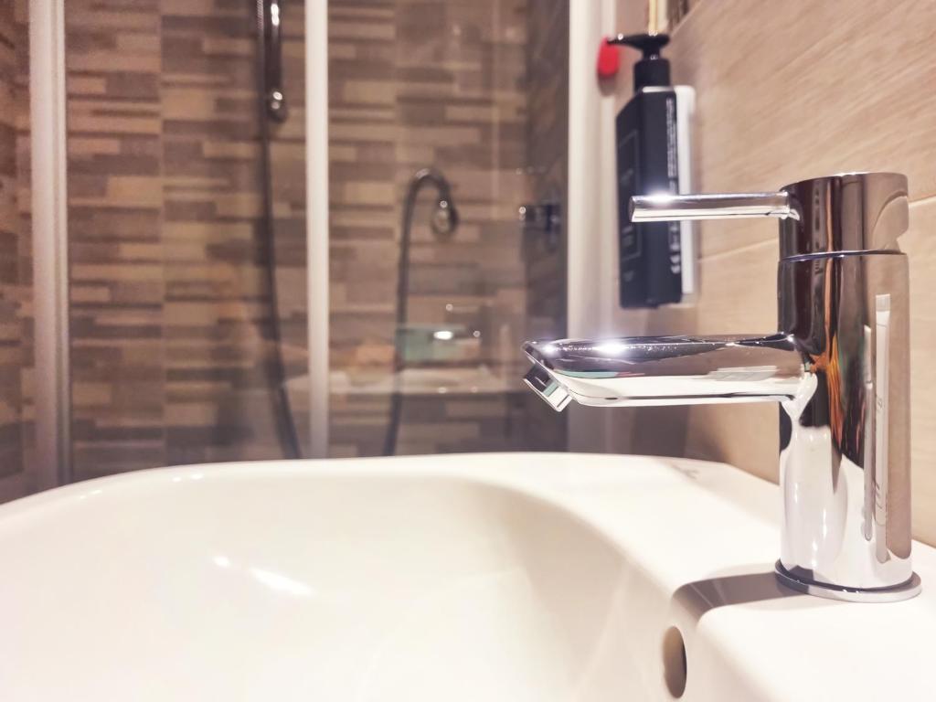 a bathroom sink with a faucet on top of it at Hotel Florida Lerici in Lerici