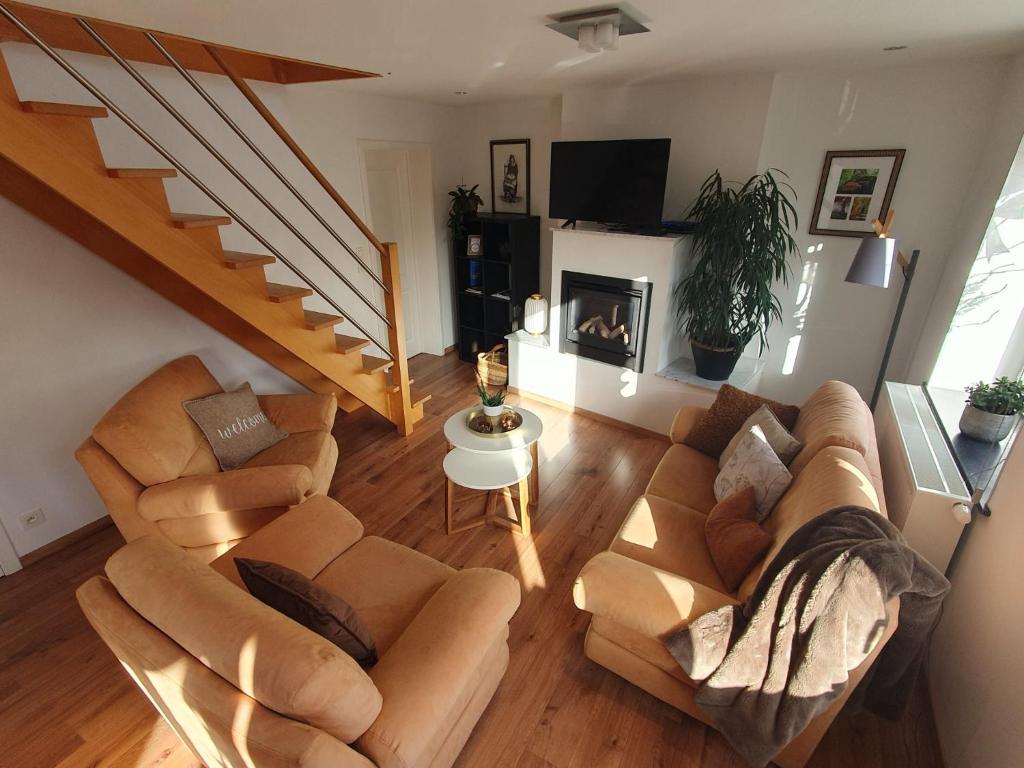 an overhead view of a living room with couches and a staircase at Duplex "Harmony" in Spa