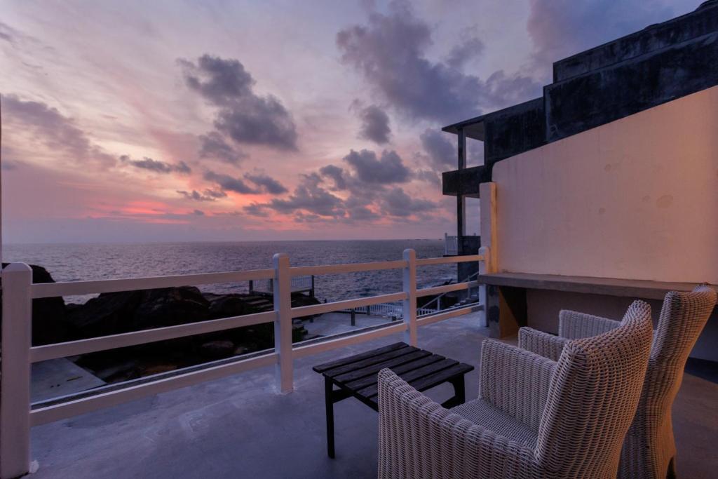 a view of the ocean from the balcony of a house at Hotel Zeilan Sunset Point in Unawatuna