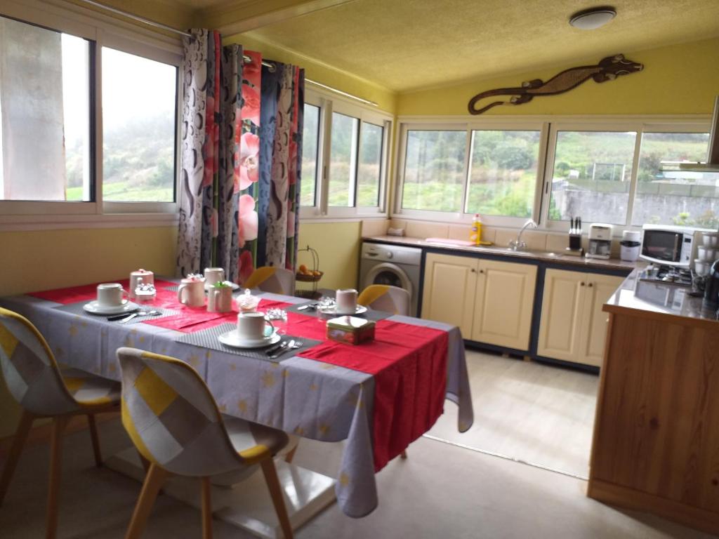 a kitchen with a table with a red table cloth at Ti kaz Payet,la fraicheur des hauts in Le Tampon