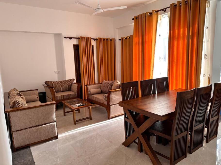 a living room with a wooden table and chairs at 2 Bedroom Apartment - Aurora Residences Maharagama in Maharagama