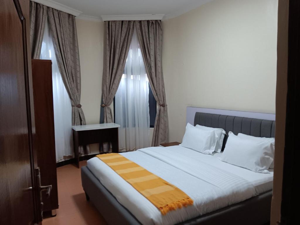 Een bed of bedden in een kamer bij La cafecito Bistro & Accommodation