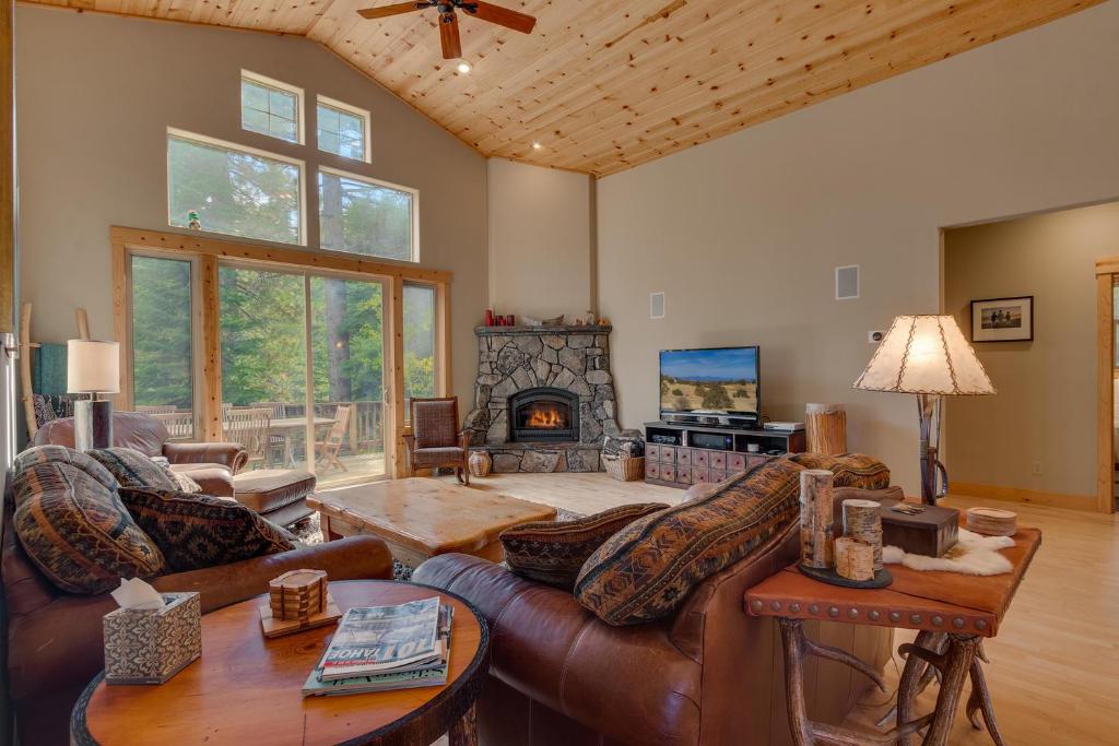 uma sala de estar com um sofá e uma lareira em High Altitude at Tahoe Donner - Huge 4 BR with Private Hot Tub, Pool Table, Ping Pong, HOA Amenities em Truckee