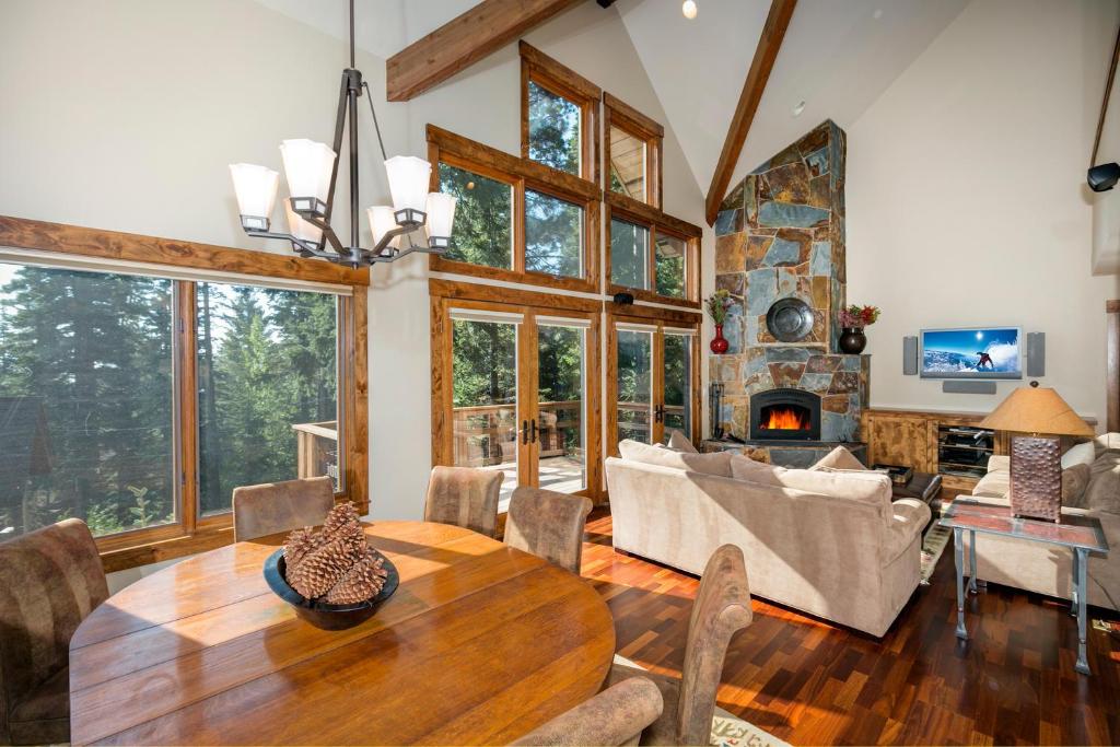 a living room with a table and a fireplace at North Shore Bliss by Tahoe Getaways - 3 BR plus loft & Private Hot Tub in Carnelian Bay