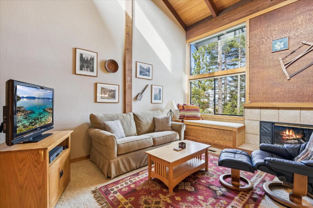 a living room with a couch and a fireplace at Rocky Point # 4 - 2 BR Northstar Condo, Shuttle to Slopes, HOA Amenities! in Truckee