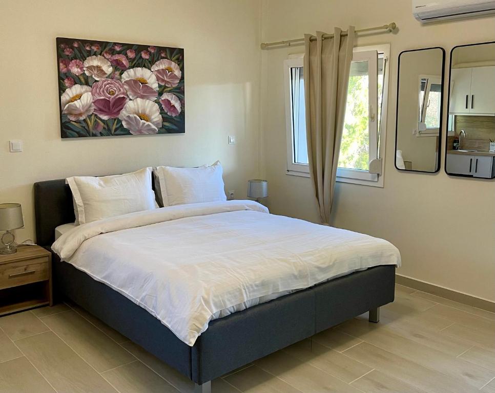 a bedroom with a large bed and a window at Lemnos Urban Escape in Myrina
