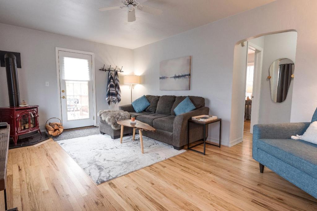 a living room with a couch and a table at Serendipity Cottage in Joseph