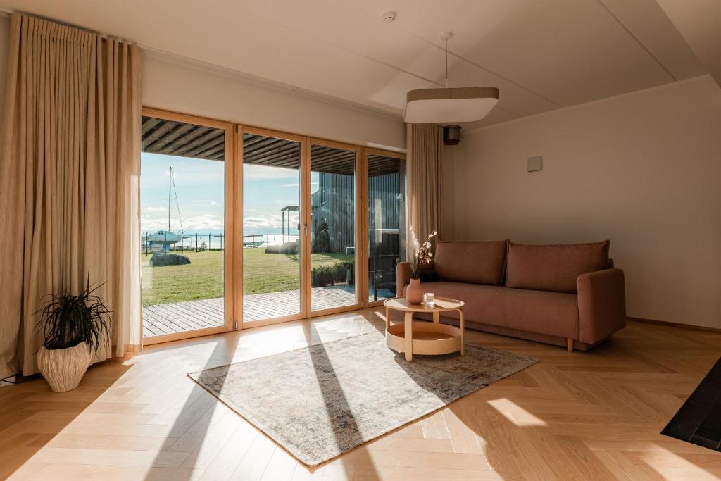a living room with a couch and a large window at Kaluri Seaview Apartment in Kuressaare