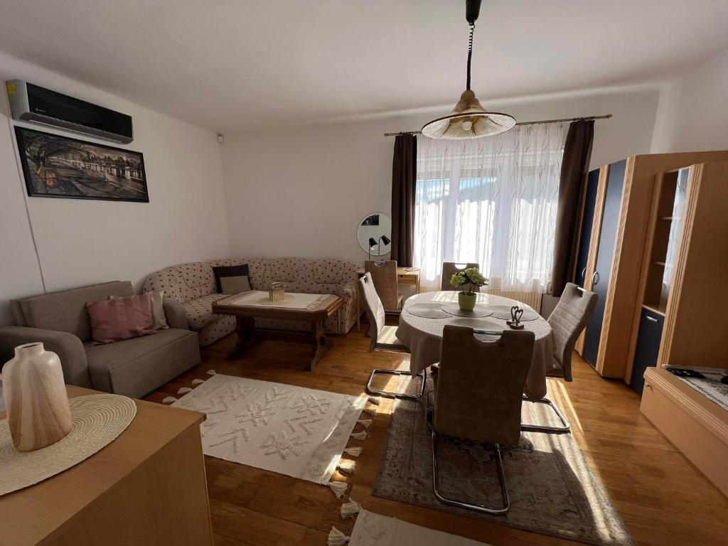 a living room with a couch and a table at Becehegyi Vendégház in Balatongyörök