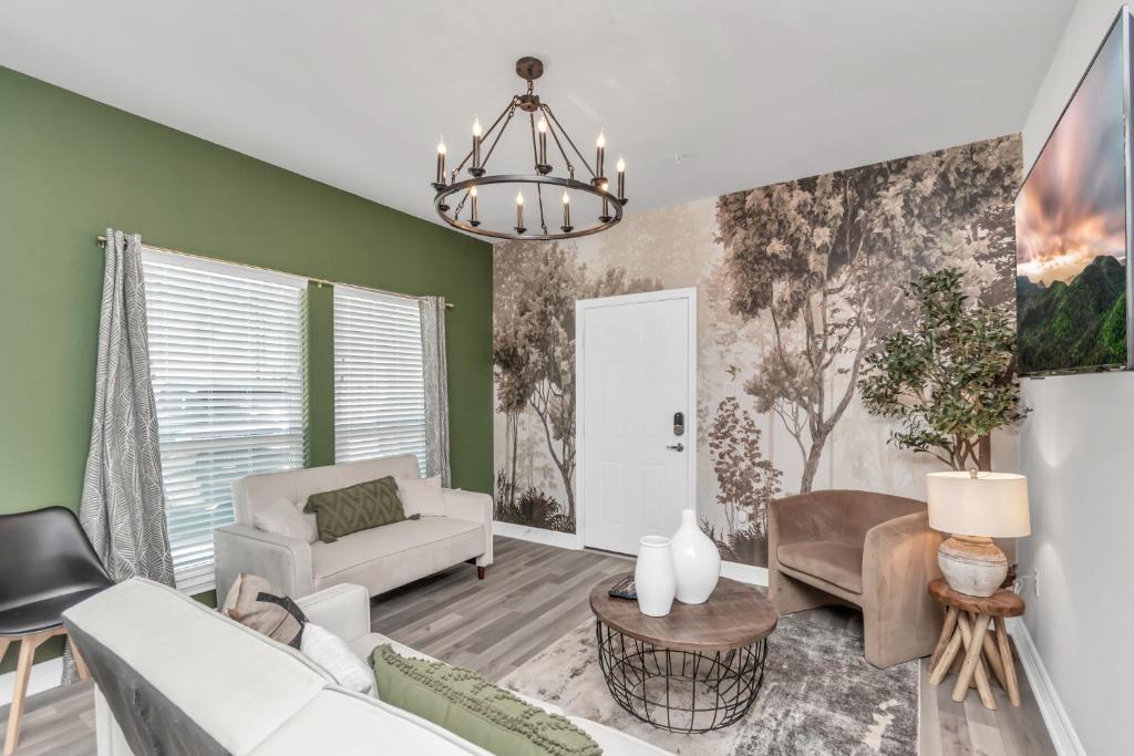 a living room with green walls and a white couch at TEXAS-Style 2 BR Apartment near NRG Stadium, University of Houston, Med Center, Gated, Wifi, Parking in Houston