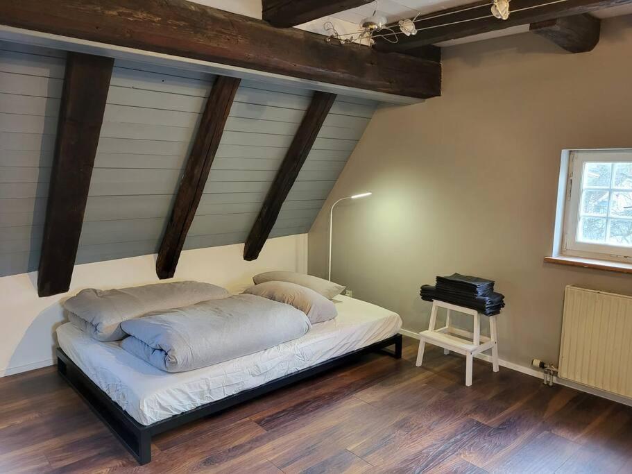 a bedroom with a bed and a desk in it at Fachwerk Maisonette in Nürtingen in Nürtingen