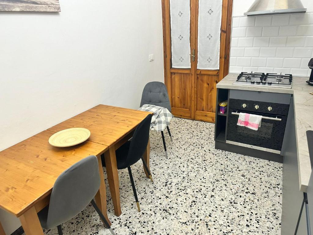 a kitchen with a wooden table with chairs and an oven at Best Apartment in Florence in Sesto Fiorentino