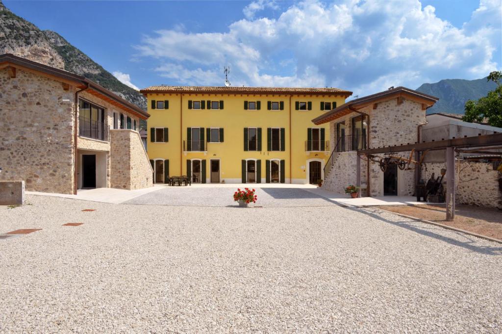 a large yellow building with a bunch of buildings at Agriturismo Tre Forti in Rivoli Veronese