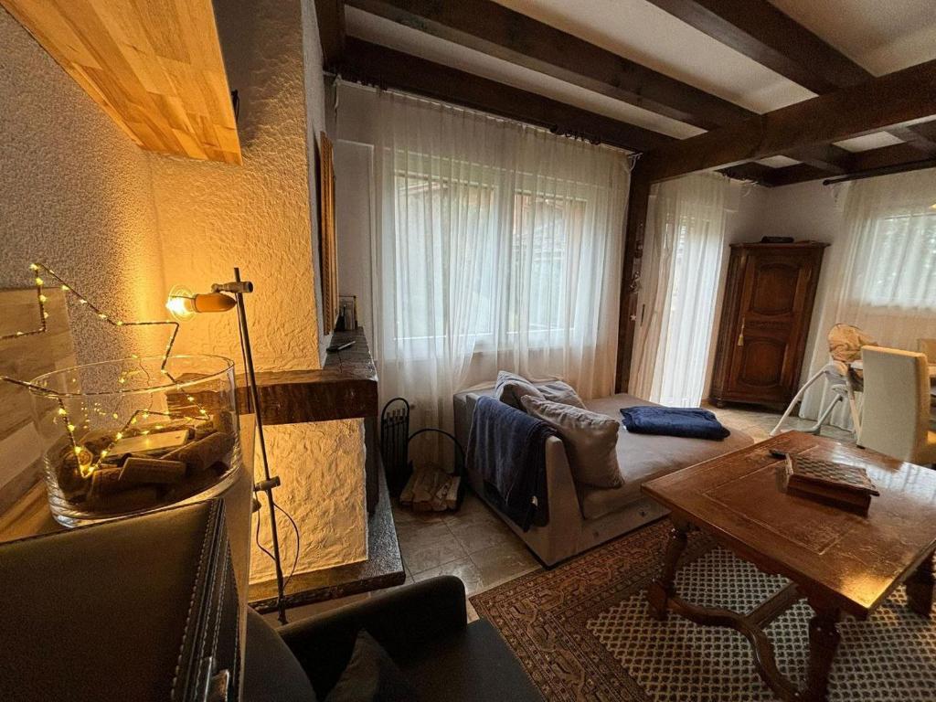 a living room with a couch and a table at Crans-Montana Duplex Lodge in Crans-Montana