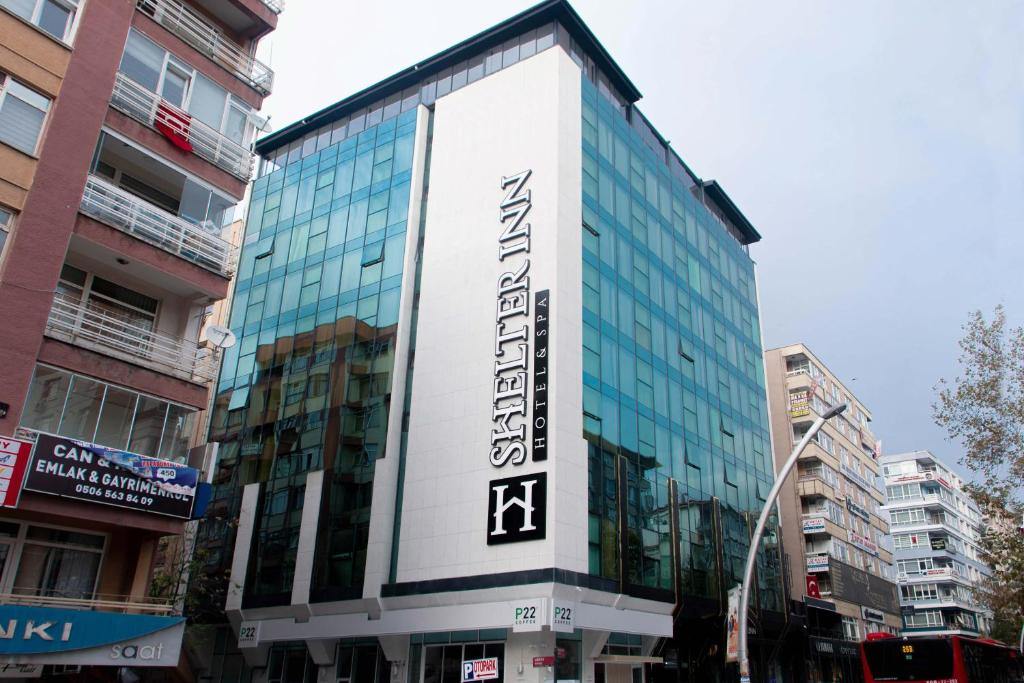 a building with a sign on the side of it at Shelter Inn Hotel & Spa in Ankara