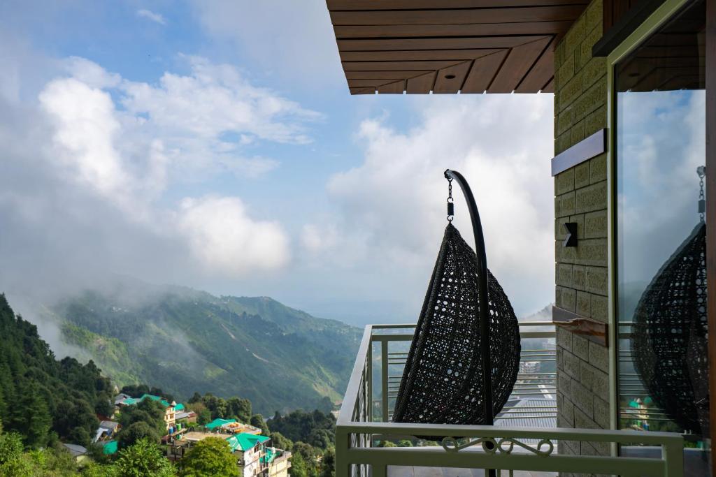 a balcony with a view of the mountains at Alt Life Luxe - Uppper Bhagsu Mcleodganj in McLeod Ganj
