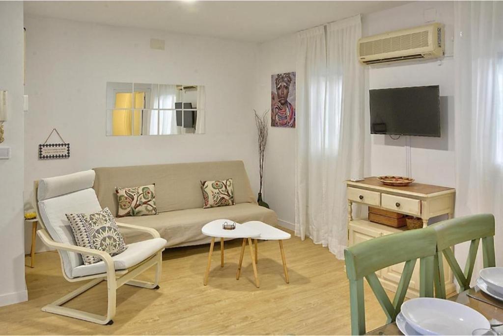 een woonkamer met een bank en een tafel bij Apartamento Triana in Sevilla