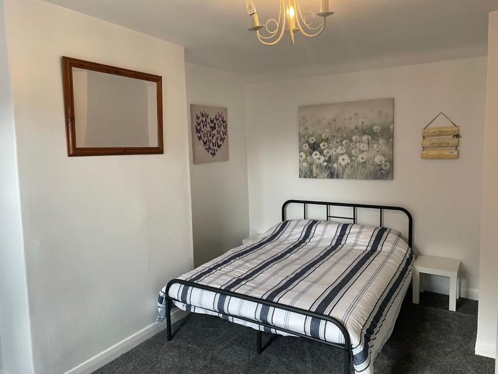 a bedroom with a bed and a mirror on the wall at Little Manor in Chesterfield