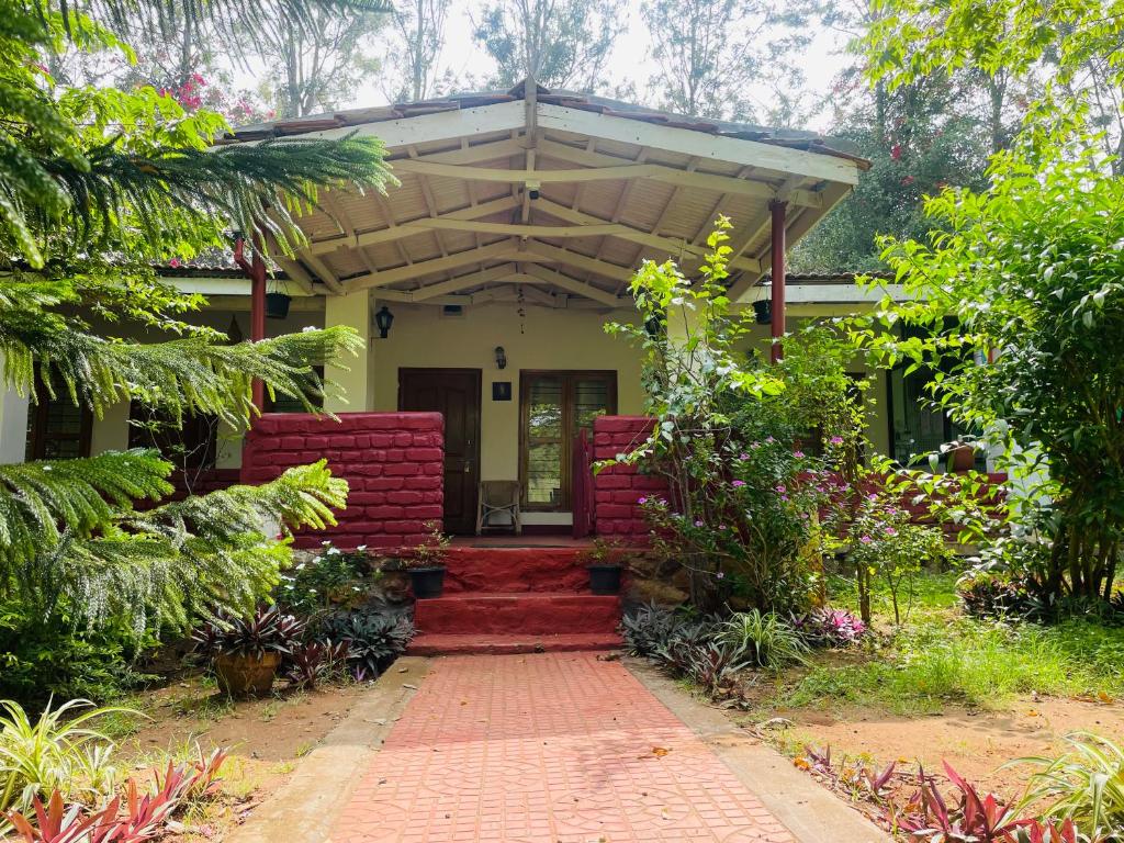 a house with a red brick walkway in front of it at Wild Valley Club in Masinagudi