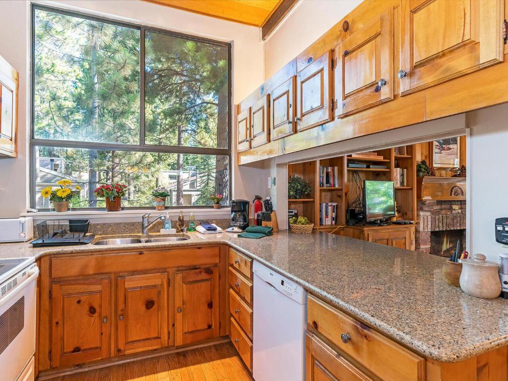 a large kitchen with wooden cabinets and a large window at 223 Forest Pines short walk to bike path and the Hyatt Casino in Incline Village