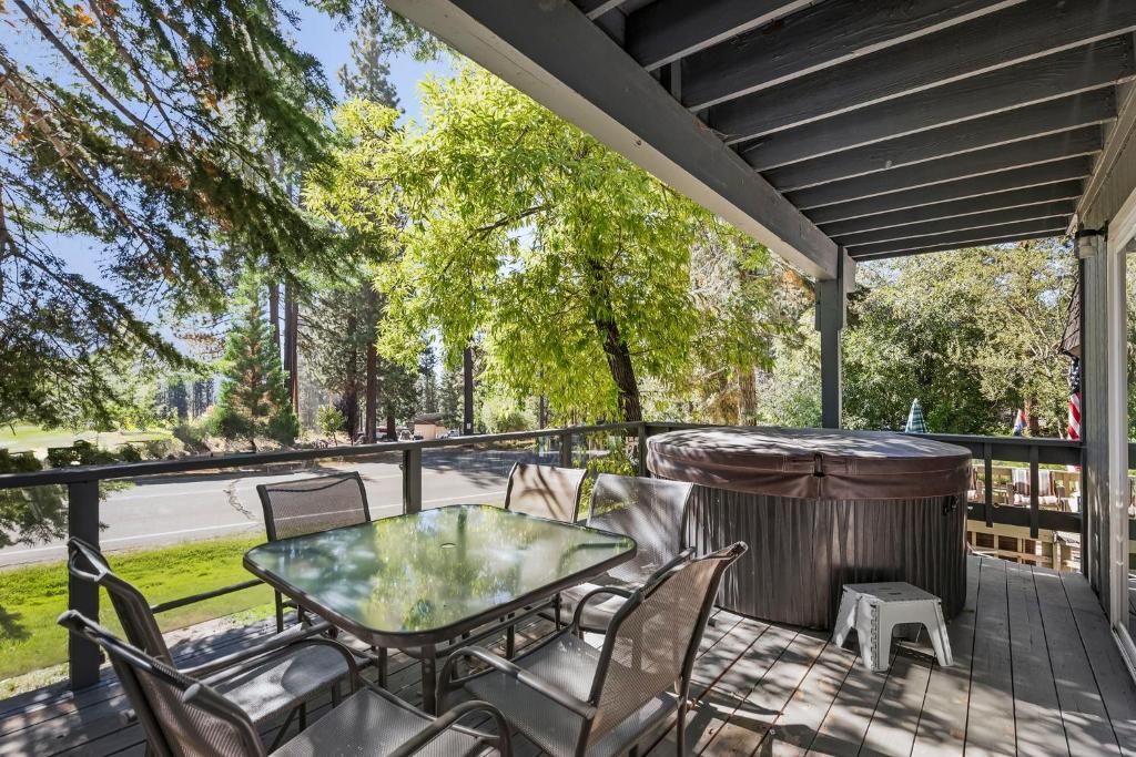 a deck with a table and chairs and a trash can at Incline Village Championship Golf Coarse Retreat in Incline Village