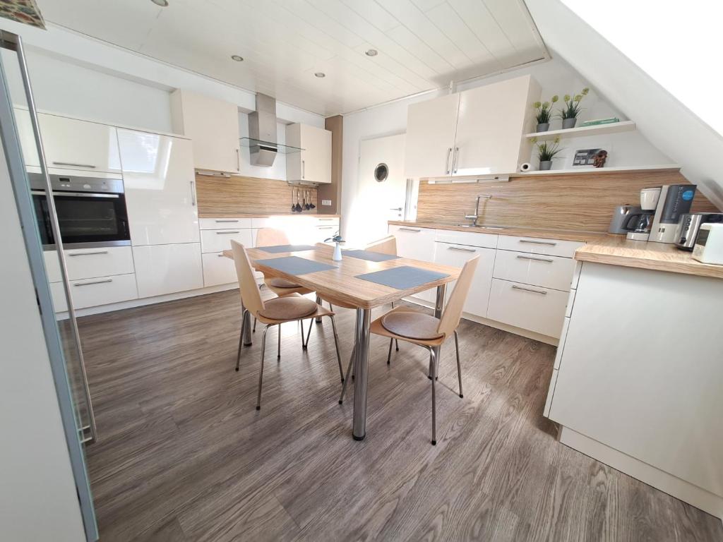 a kitchen with a table and chairs in a room at Hortensie Speyer in Speyer