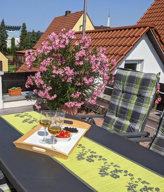 a table with glasses of wine and a plate of food at Hortensie Speyer in Speyer