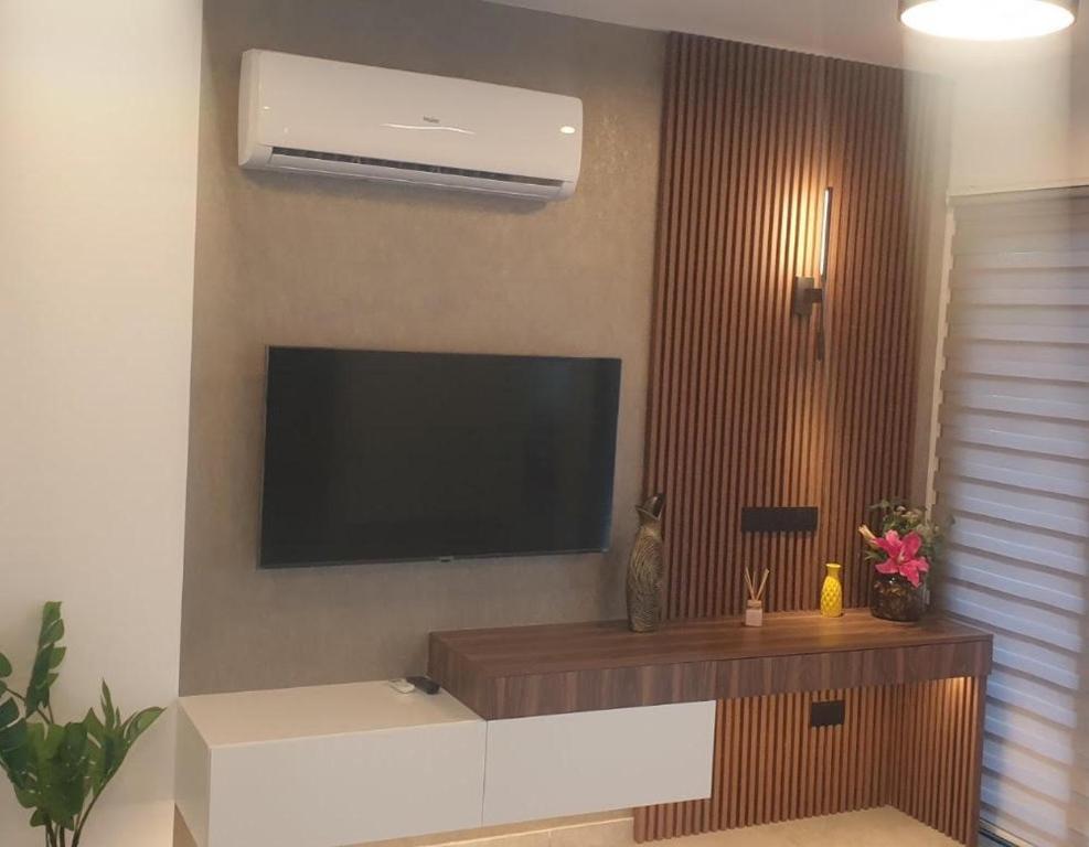 a living room with a flat screen tv on the wall at Deluxe 1 Bed Apt Ayios Dometios in Ayios Dhometios