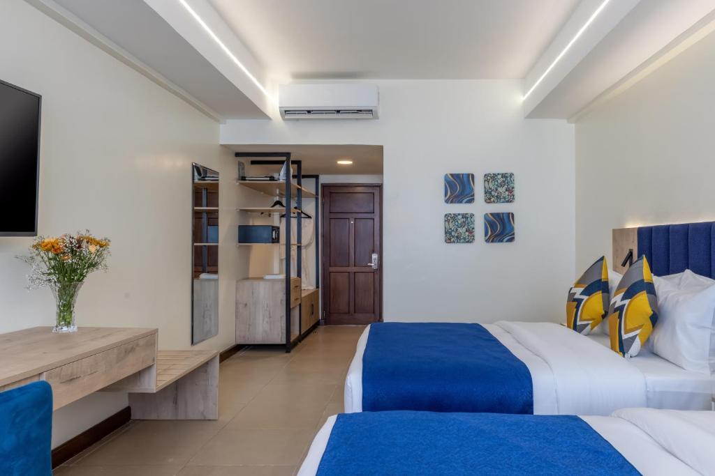 Postel nebo postele na pokoji v ubytování Premium Inn Mombasa City