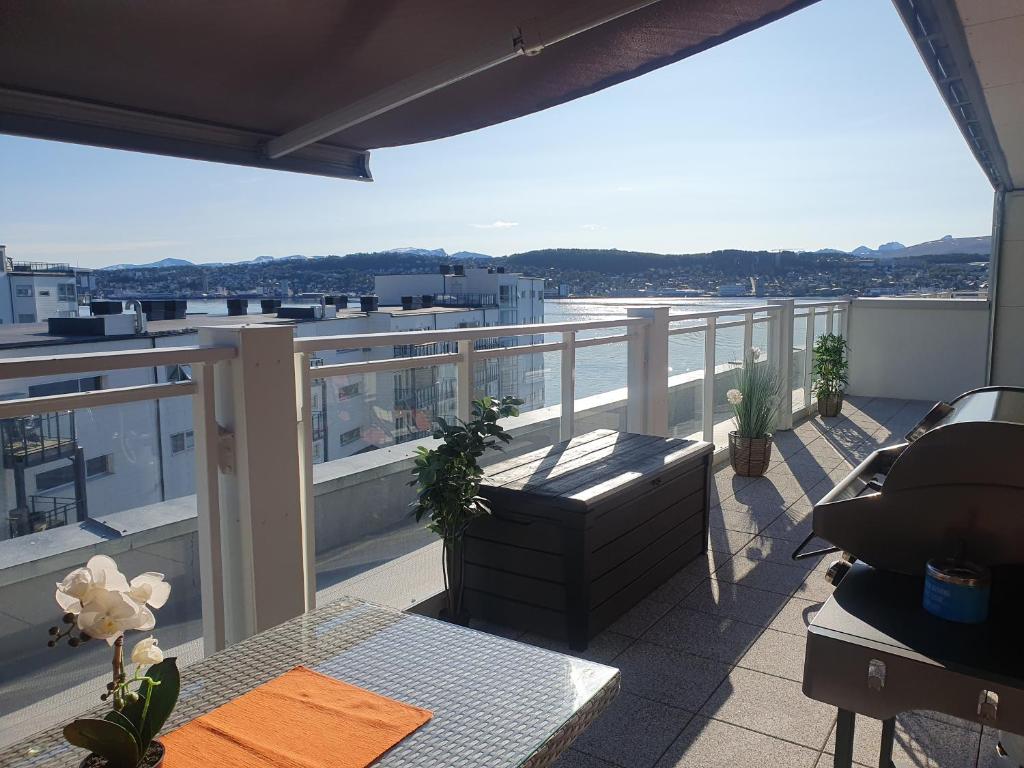 an apartment balcony with a view of a city at Top Apartment in Tromsø