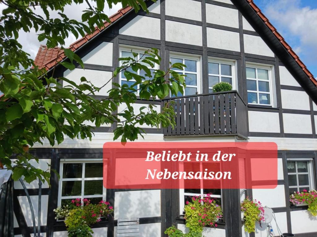 a sign in front of a house with a balcony at Landidylle mit Garten, Whirlpool und Klima in Reken